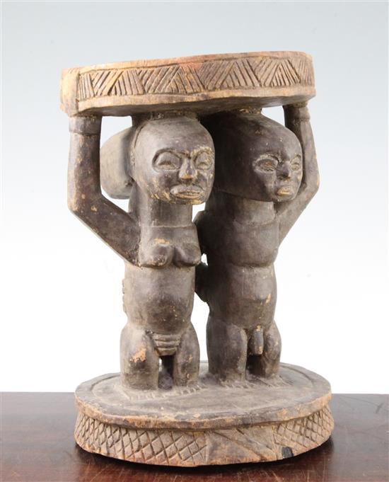 A Yoruba carved wood stool, height 11in.